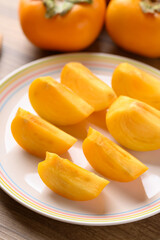 Sliced ripe persimmon ready to eating, Autumn fruit