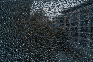 Broken glass on the window of an old building. Abstract background.