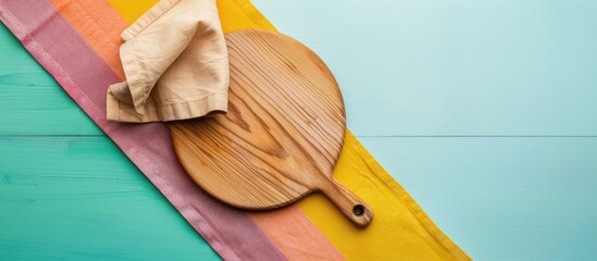 Top view of cutting board with napkin on colorful background providing copy space image