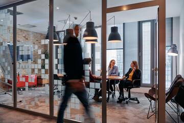 In the dynamic hustle and bustle of a business environment, a group of young business professionals...