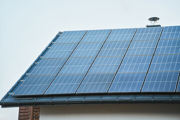 Fototapeta premium Modern home with solar panel roof generating clean energy