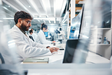 Scientist, man and typing in laboratory on computer for medical results, investigation and pharmaceutical research. Male person, science and innovation for clinical study, review and development.