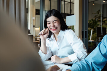 Fototapeta premium Smiling Businesswoman in Modern Office Environment Engaging in a Productive Meeting with Colleagues