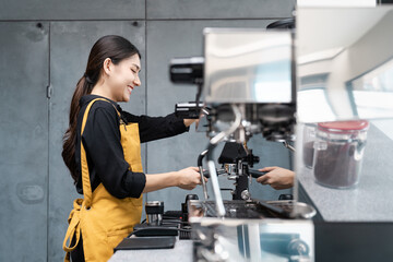 Fototapeta premium Barista Preparing Coffee Using Espresso Machine in Modern Cafe with Industrial Design