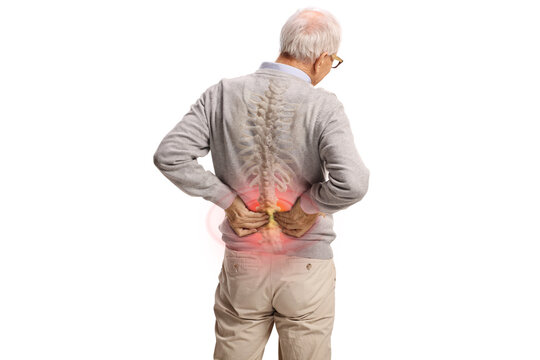 Rear view shot of an elderly man in pain holding his lower back with red painful spot