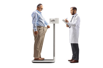 Mature man at a weight loss clinic standing on a weight scale