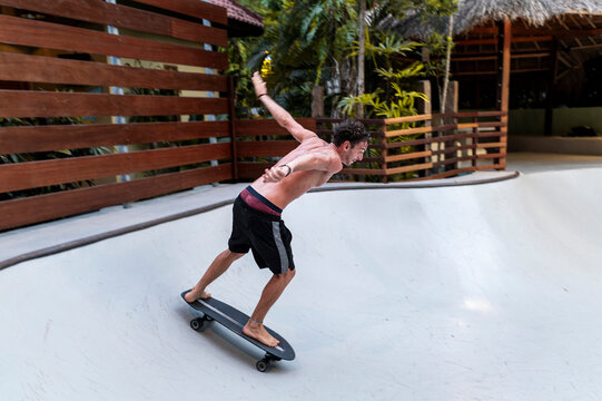 Barefoot skater accelerating on curve