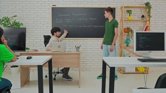 Student and Instructor Discuss Python Code in Modern Classroom