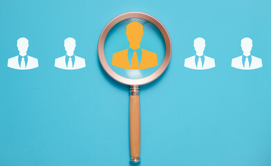 HRM vision Magnifier glass zooms in on manager icon, symbolizing the strategic role of human resource management in human development, recruitment, and leadership. employees selection.