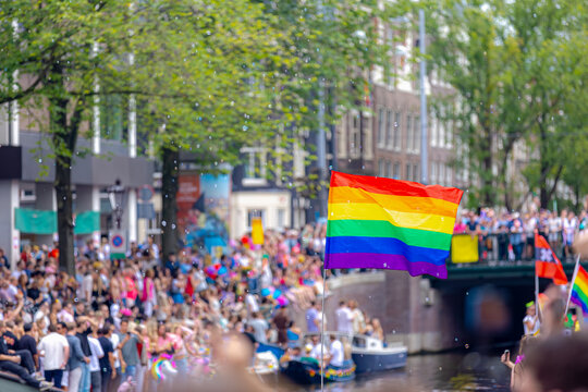 Amsterdam canal parade, Decoration with colourful rainbow flags along canals and street, LGBTQ community, Annual festival to celebrate in August, One of the greatest events in the world, Netherlands.