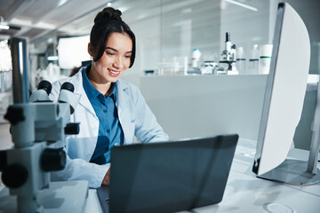 Laptop, science and smile with woman in laboratory for development, innovation or research....