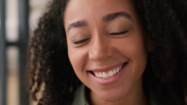 Close up smiling laughing African American woman happy face girl lady female girlfriend homeowner carefree joyful funny cheerful positive emotions laugh fun joke healthy toothy smile looking at camera