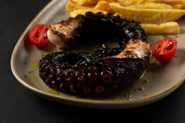 Delicious gourmet grilled octopus on plate. Seafood background.