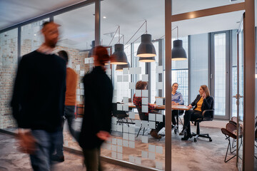 In the dynamic hustle and bustle of a business environment, a group of young business professionals...