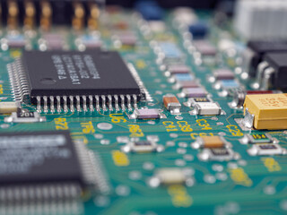Close-up of microcircuits and components: chips, diodes and capacitors on a printed circuit board,...