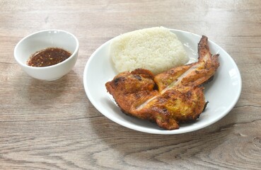roasted chicken wing eat couple sticky rice on plate dipping with spicy sauce 