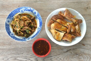 roasted chop chicken dipping dipping spicy sauce with slice boiled pork Thai salad taste spicy and sour on plate