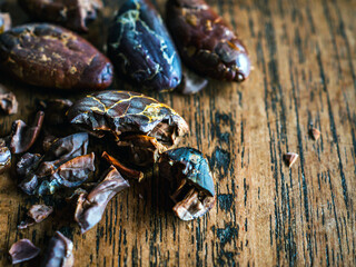 Cocoa beans,close-up of cocoa bean on wooden table,  dried broken cocoa beans