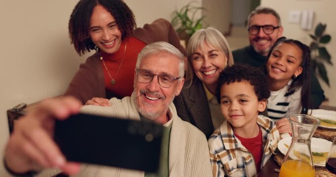 Happy interracial family, dining and food with selfie for thanksgiving, memory or photography together at home. Grandparents, parents and children with smile for group picture moment at dinner table