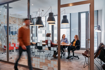 In the dynamic hustle and bustle of a business environment, a group of young business professionals...