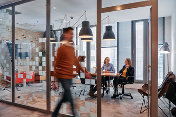 In the dynamic hustle and bustle of a business environment, a group of young business professionals...