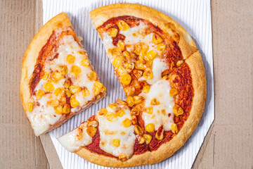 Pizza with corn and mozzarella cheese on a white background.