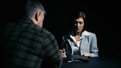 Woman lawyer visiting her male client, opening case with information to discuss details