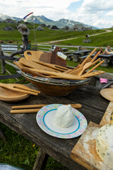 Fototapeta premium Velika Planina, Kamnik, Slovenia. Lord of the Rings style village. Wooden typical houses, hills, green meadows, flowers where cows and calfs graze. High quality artisanal milk and cheeses. Holiday.