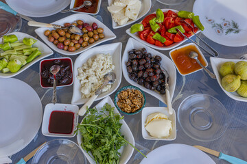 Turkish breakfast table. Cheese, Butter, Olives, Tomato, Honey, Jam, Turkish bagel (Crispy), Walnuts, Cucumber, Omelet.