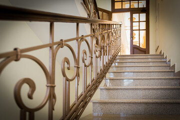 Retro styled marble staircase with handrails in a hotel