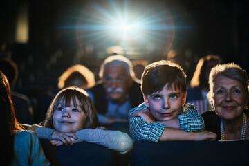 Children and grandparents enjoying movie night at the theater