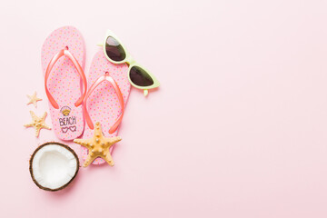Top view composition of flip flops placed with beach accessories top view on table background....