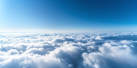 Fototapeta premium Bird’s Eye View Over a Blanket of Clouds Under a Clear Blue Sky