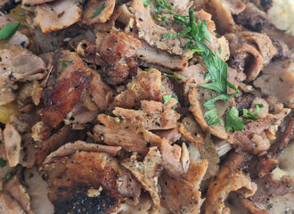Messy Portion of Served Gyros: Pieces of Pork Meat and Parsley - Food Photography Background.