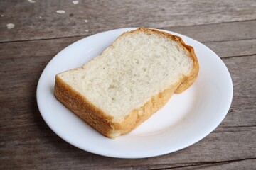Breakfast of sliced bread on wood background