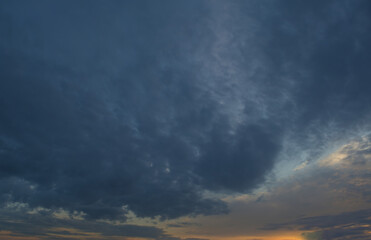 Summer evening sky in the picturesque clouds, lit by the rays of the setting sun.