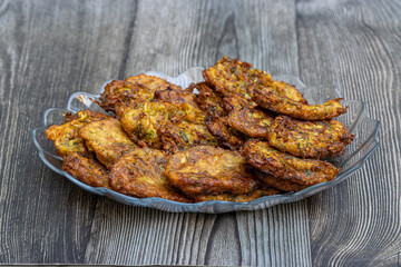 Zucchini fries or Latkes made with grated zucchini, eggs, flour, and Turkish yoghurt.