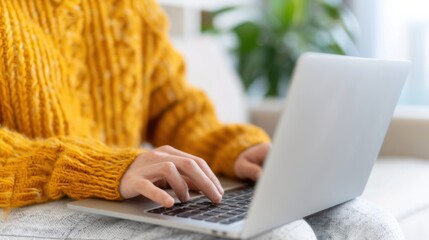 A man sitting on a couch with a laptop, filling out a detailed job application form online