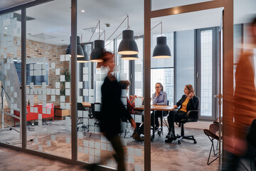 In the dynamic hustle and bustle of a business environment, a group of young business professionals...