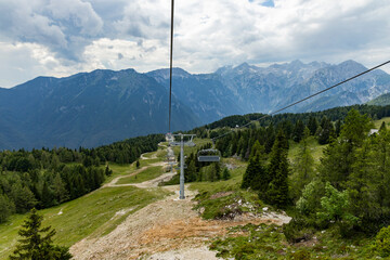 Velika Planina, Kamnik, Slovenia. Lord of the Rings style village. Wooden typical houses, hills, green meadows, flowers where cows and calfs graze. High quality artisanal milk and cheeses. Holiday.