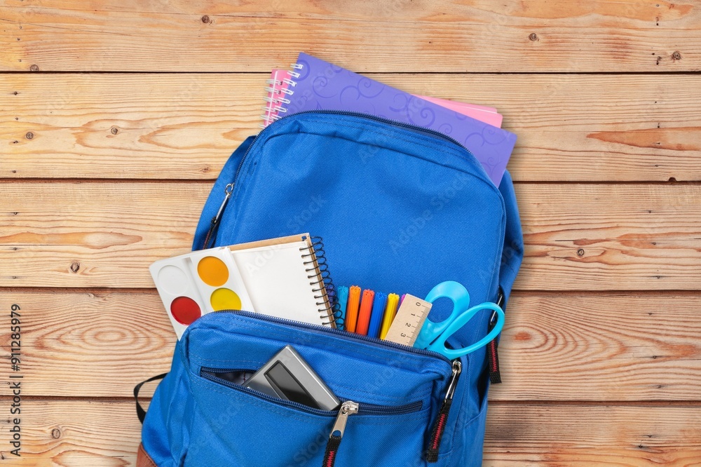 Sticker School supplies in Backpack on desk background