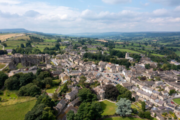 Aerial drone photo of the beautiful town of Middleham in Leyburn in North Yorkshire in the UK showing the British countryside town and the historic Middleham Castle on a sunny day in the summer time © Duncan