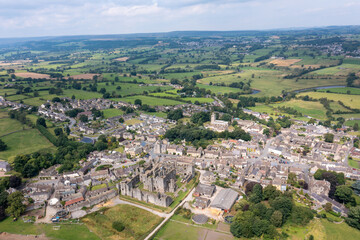 Obraz premium Aerial drone photo of the beautiful town of Middleham in Leyburn in North Yorkshire in the UK showing the British countryside town and the historic Middleham Castle on a sunny day in the summer time