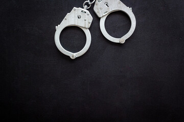 Close up police metal handcuffs, top view. Criminal law and justice concept