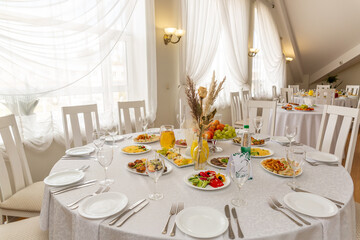 Wedding banquet in restaurant, covered round table for guests