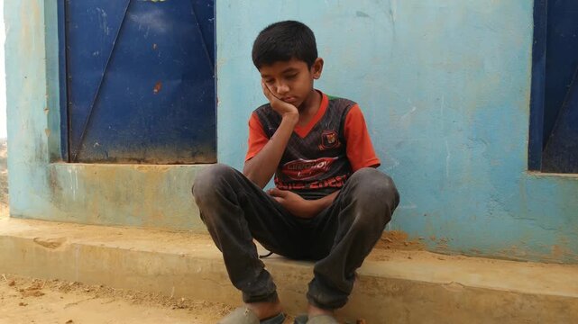 One rohingya kid is thinking about his future and sat on near toilet