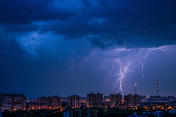 Fototapeta premium Lightning strikes in sky over cityscape at dusk. Lightning thunderstorm flashes in night. Dangerous weather conditions