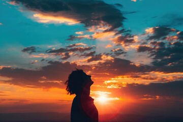 Fototapeta premium Silhouette of a person with a bright sunset