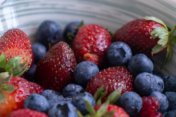 Blueberries and strawberries closeup. Summer berries