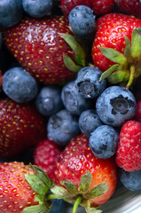 Blueberries and strawberries closeup. Summer berries